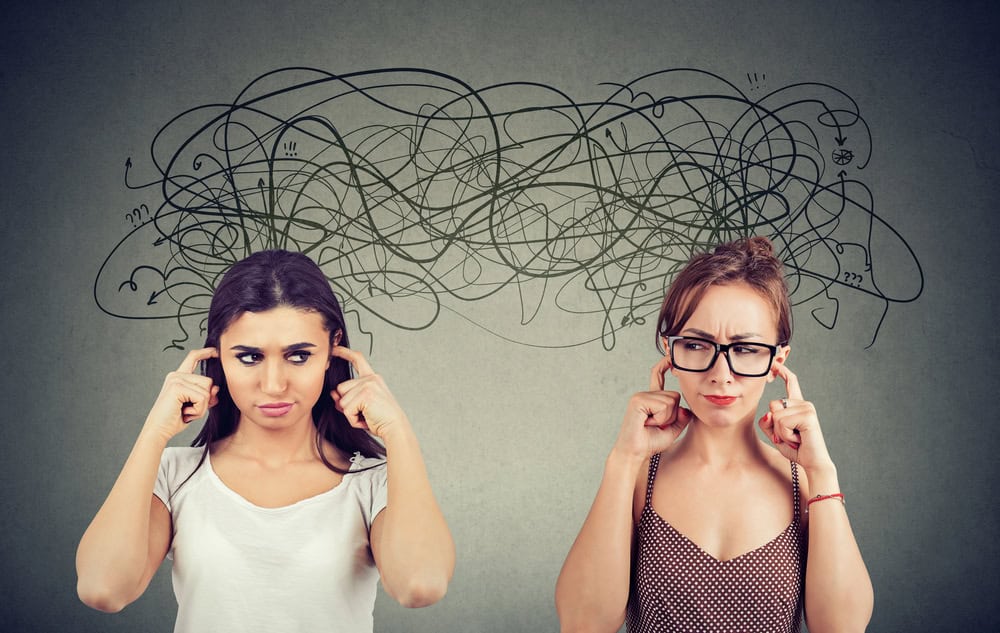 Two women looking confused with tangled thoughts above their heads.