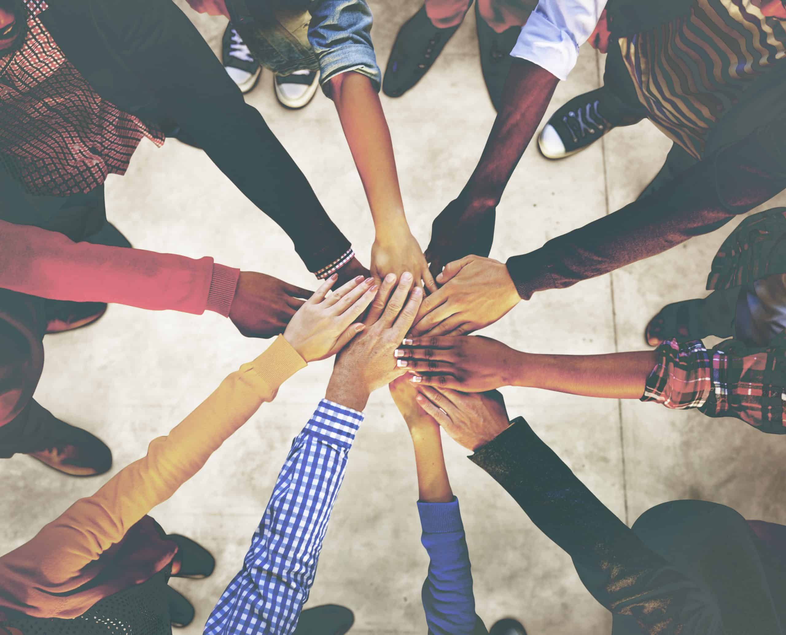Group of Diverse Multiethnic People Teamwork Concept Diverse group of people putting hands together in a teamwork gesture for collaboration and unity.