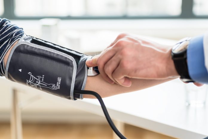 Hand of a doctor measuring the blood pressure of a patient