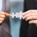 businessman and businesswoman with puzzle pieces